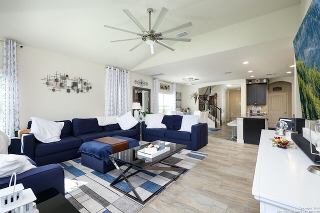 living room with ceiling fan and lofted ceiling