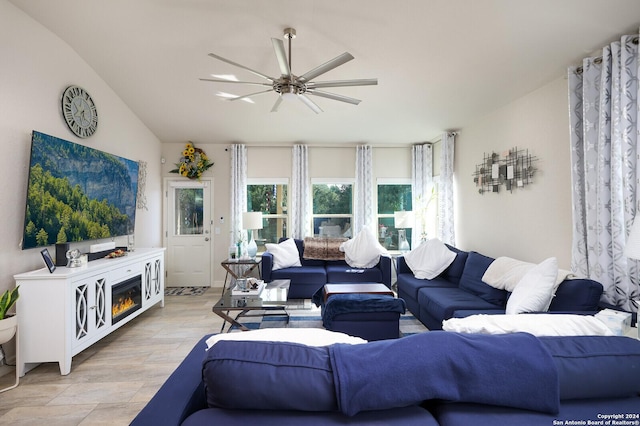 living room with ceiling fan, a fireplace, and light hardwood / wood-style flooring