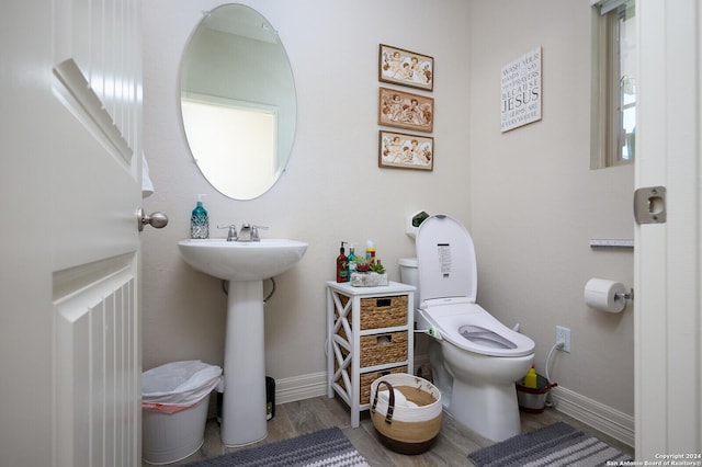 bathroom featuring hardwood / wood-style flooring, sink, and toilet