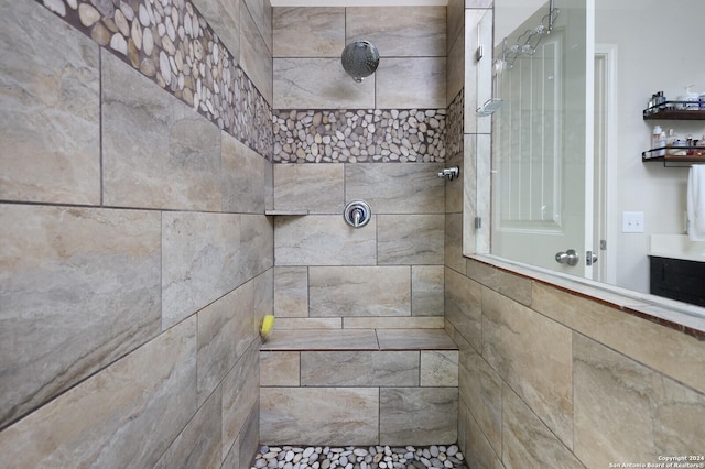 bathroom with tiled shower