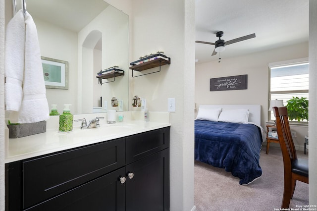 bedroom featuring ceiling fan, light colored carpet, and sink