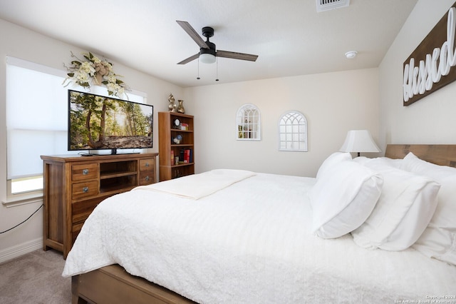 bedroom featuring multiple windows, ceiling fan, and carpet floors