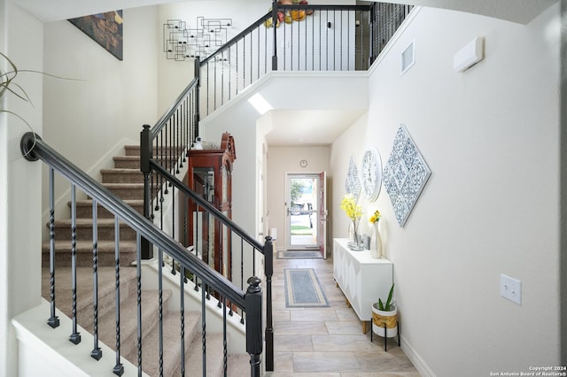 staircase with a high ceiling