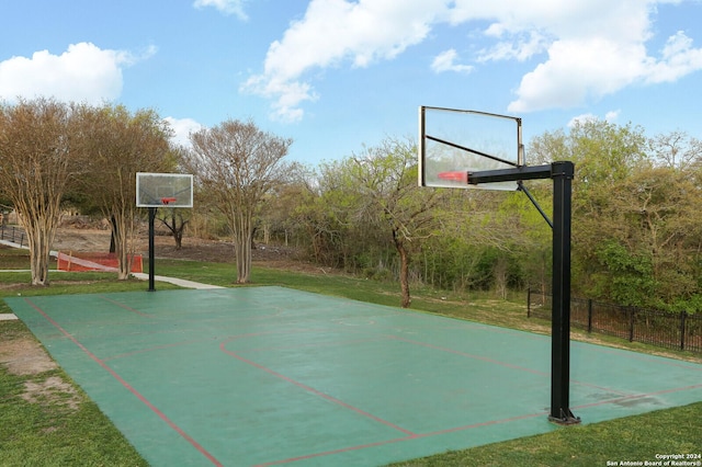 view of basketball court featuring a yard