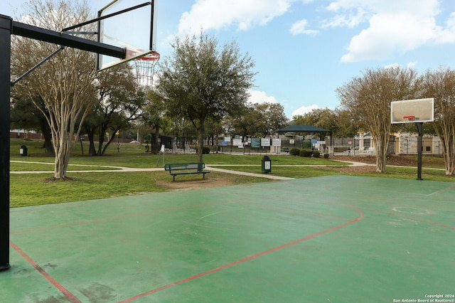 view of basketball court with a yard