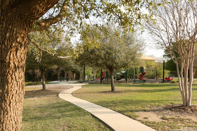 view of community with a lawn and a playground