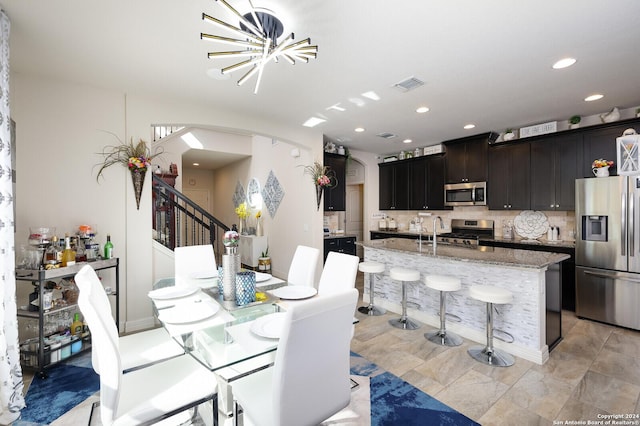 dining area featuring a notable chandelier