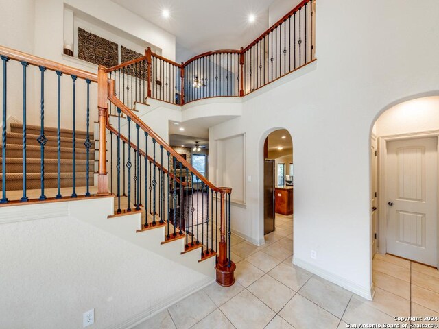 kitchen with a kitchen island, light stone countertops, appliances with stainless steel finishes, decorative backsplash, and sink