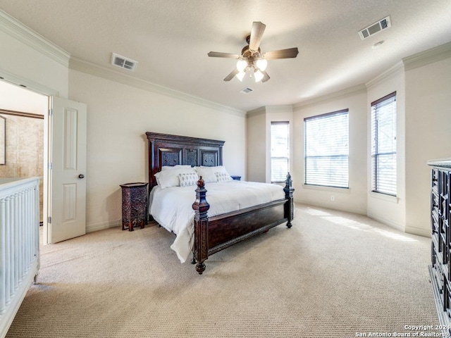 bedroom with light carpet, visible vents, and crown molding