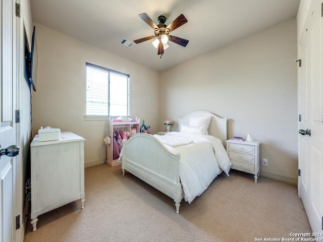 bedroom featuring visible vents, baseboards, light colored carpet, and a ceiling fan