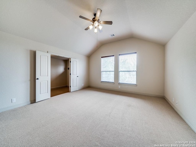 bonus room with visible vents, a ceiling fan, baseboards, light colored carpet, and vaulted ceiling