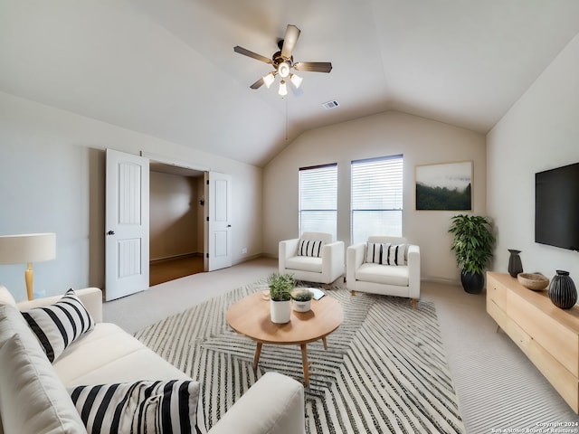 carpeted living room featuring visible vents, ceiling fan, and vaulted ceiling