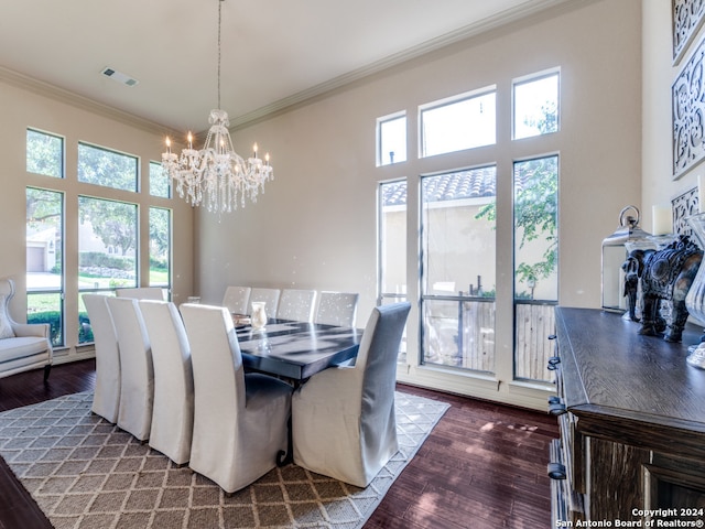 dining room with dark hardwood / wood-style floors, a notable chandelier, and ornamental molding