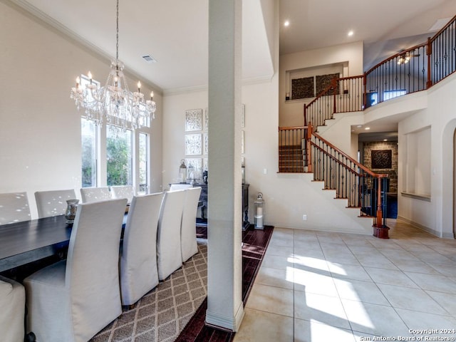 tiled dining space featuring visible vents, ornamental molding, stairway, a high ceiling, and an inviting chandelier