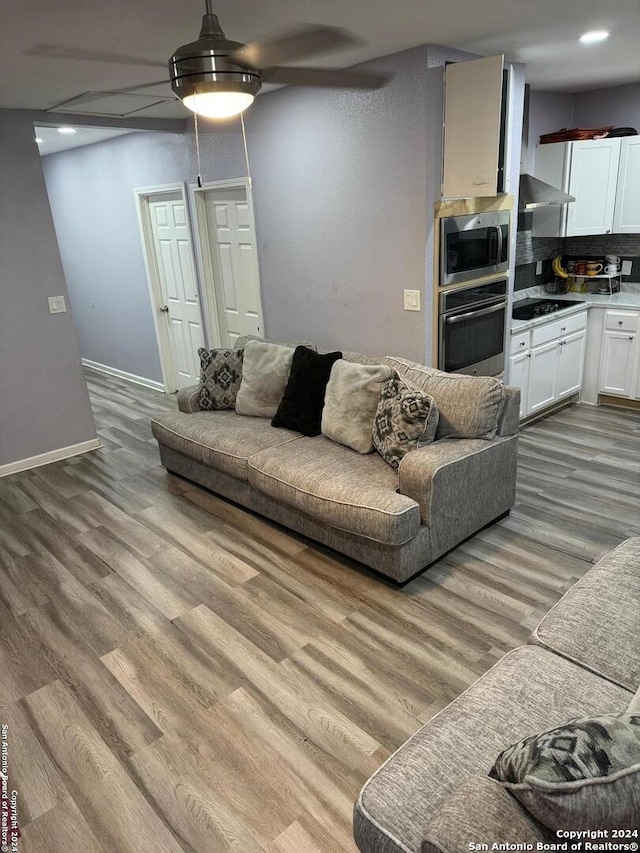 living room with ceiling fan and light hardwood / wood-style floors