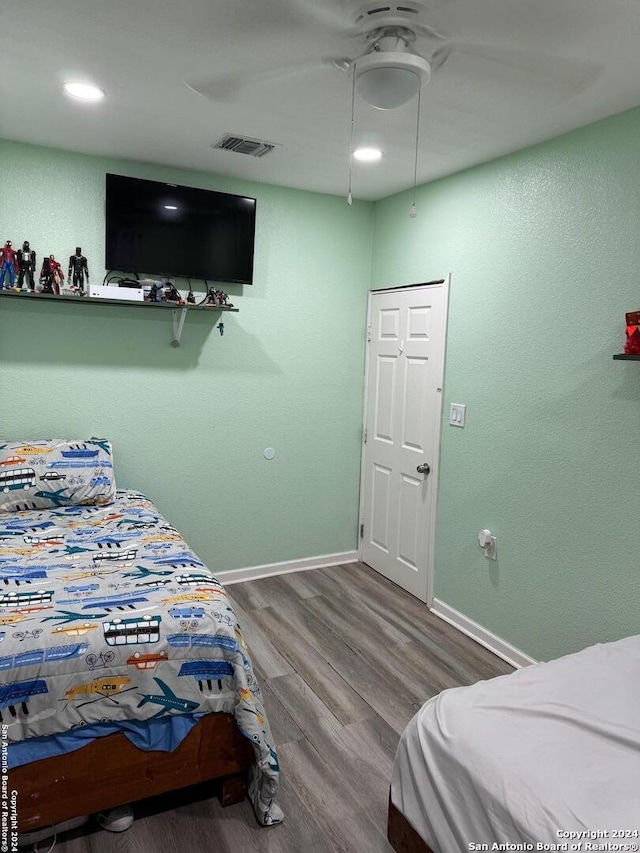 bedroom with hardwood / wood-style flooring and ceiling fan