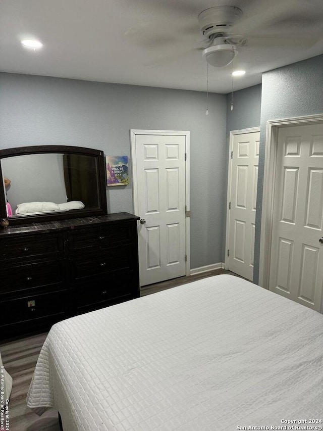 bedroom featuring ceiling fan and dark wood-type flooring