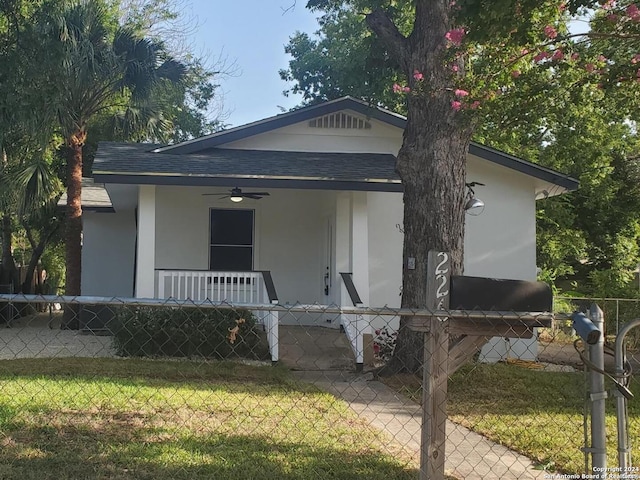 bungalow-style house featuring ceiling fan and a front lawn