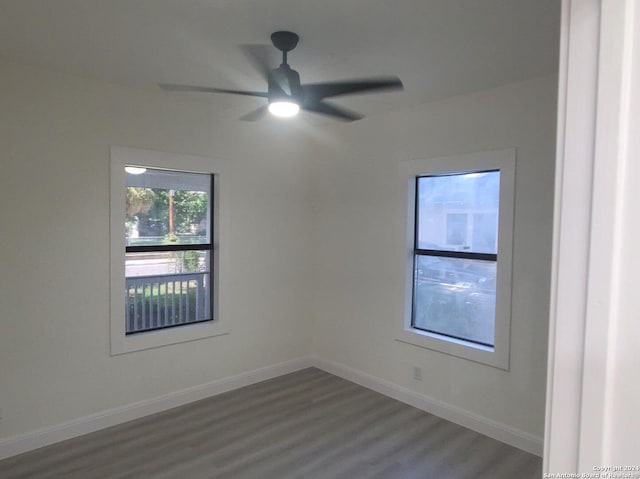 unfurnished room featuring ceiling fan and dark wood-type flooring