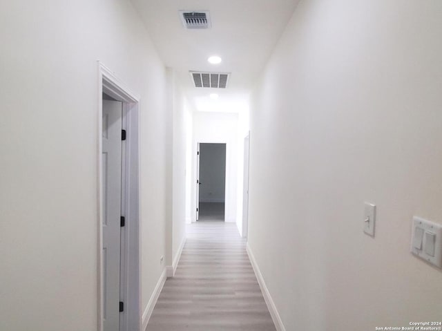 hallway with wood-type flooring