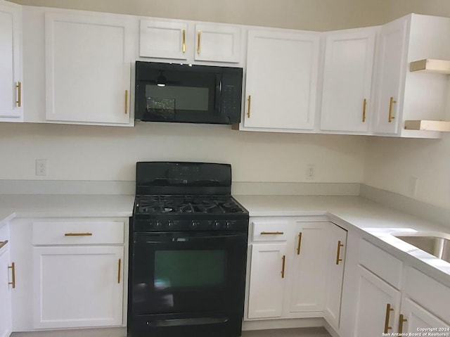 kitchen featuring white cabinetry and black appliances