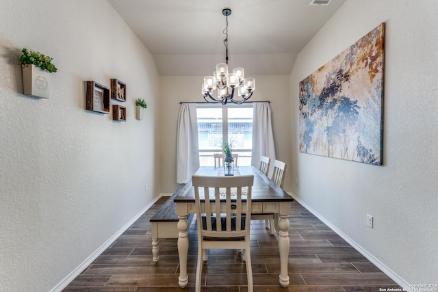 dining area featuring a chandelier and vaulted ceiling