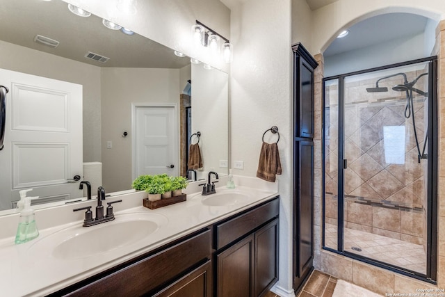 bathroom with vanity and a shower with door