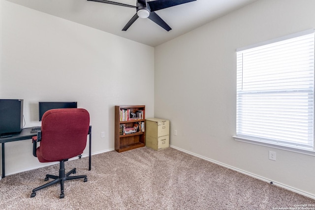 carpeted office space with ceiling fan