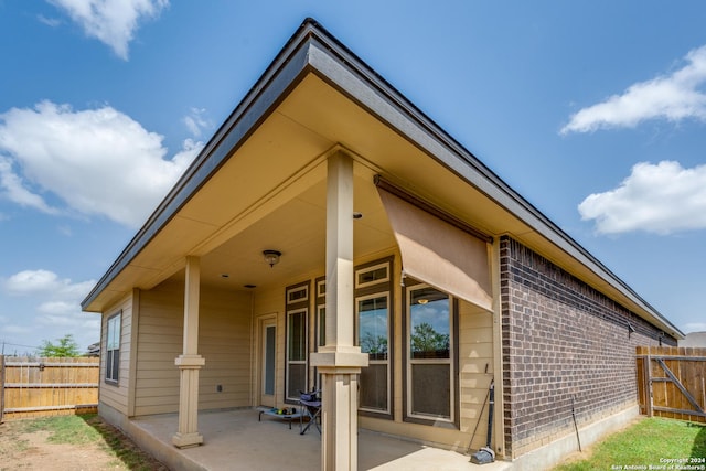 view of side of property featuring a patio