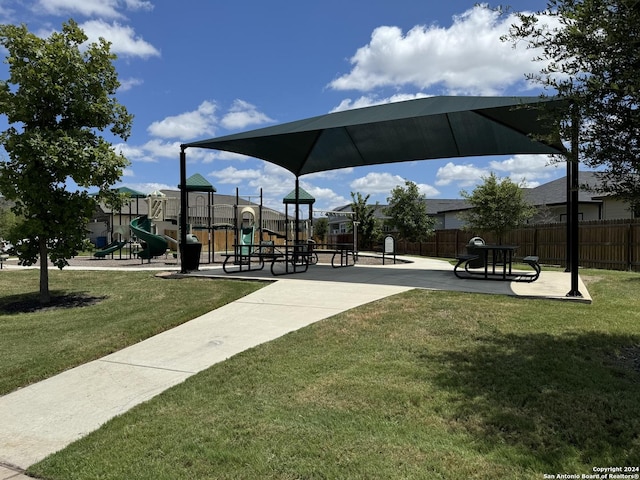 surrounding community featuring a playground and a yard