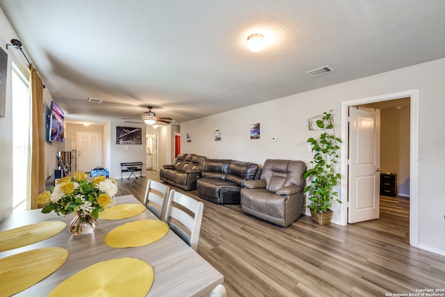 interior space featuring ceiling fan, a textured ceiling, and hardwood / wood-style flooring