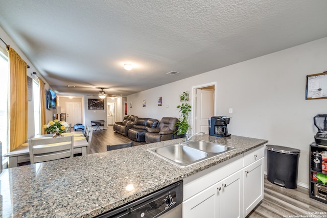 kitchen with white cabinetry, ceiling fan, stone counters, light wood-type flooring, and sink