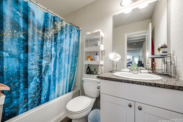 full bathroom with shower / tub combo with curtain, vanity, and toilet