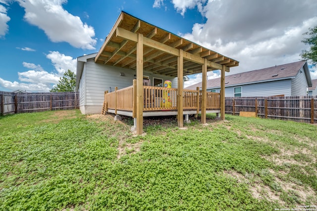 back of house featuring a deck and a yard