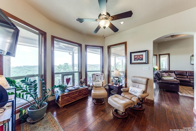 living area with a textured ceiling and dark wood-type flooring