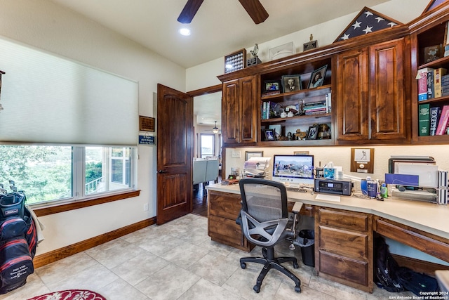 office area featuring a healthy amount of sunlight, ceiling fan, and built in desk