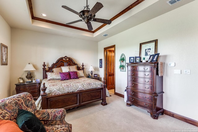 bedroom featuring a tray ceiling, ceiling fan, light colored carpet, and ornamental molding