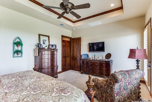 carpeted bedroom with a raised ceiling, ceiling fan, and ornamental molding