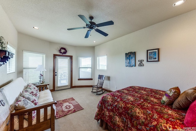 bedroom with light carpet, a textured ceiling, and ceiling fan