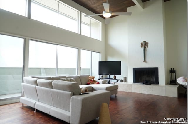 living room featuring wood ceiling, a fireplace, ceiling fan, and wood-type flooring