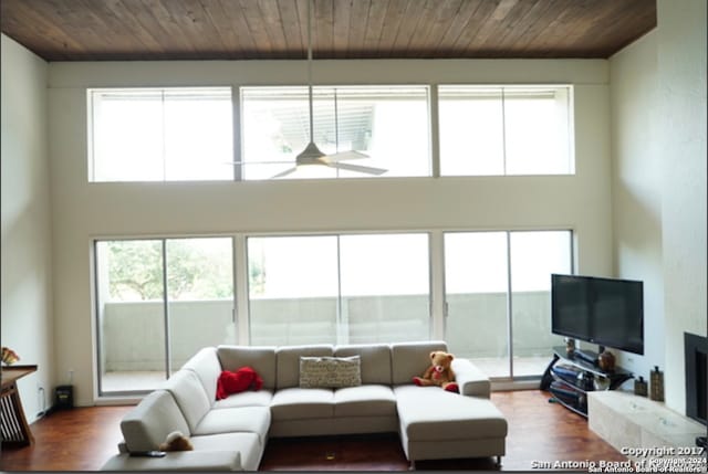 living room with hardwood / wood-style flooring, wood ceiling, and plenty of natural light