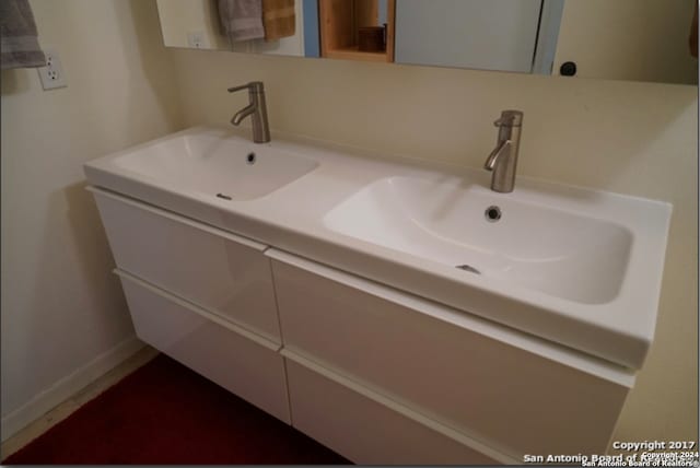 bathroom featuring dual vanity