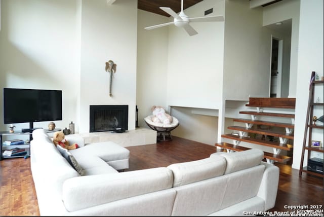 living room featuring wood-type flooring, ceiling fan, and high vaulted ceiling