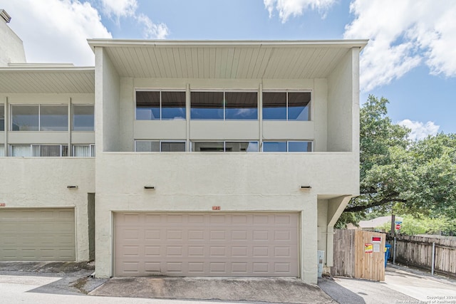 view of front of property with a balcony and a garage