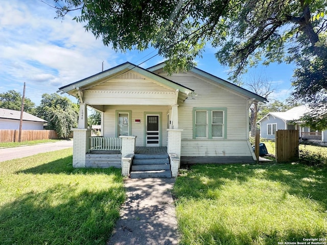 bungalow featuring a porch and a front yard