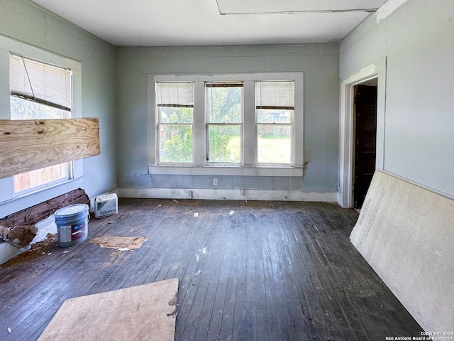 unfurnished living room with dark hardwood / wood-style flooring