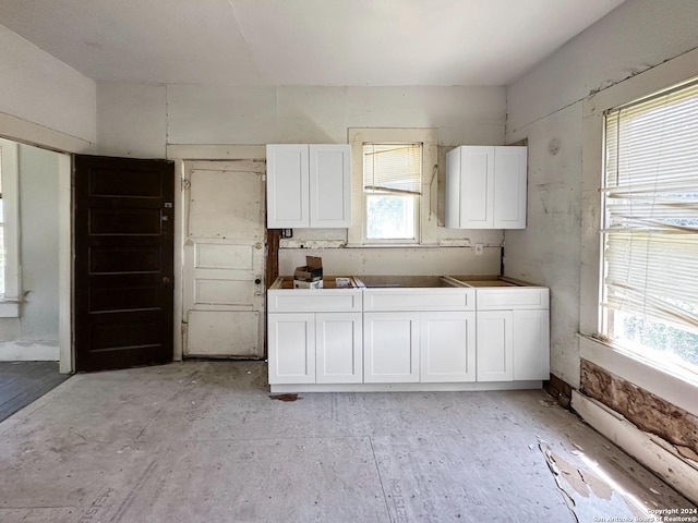 kitchen featuring white cabinets and plenty of natural light