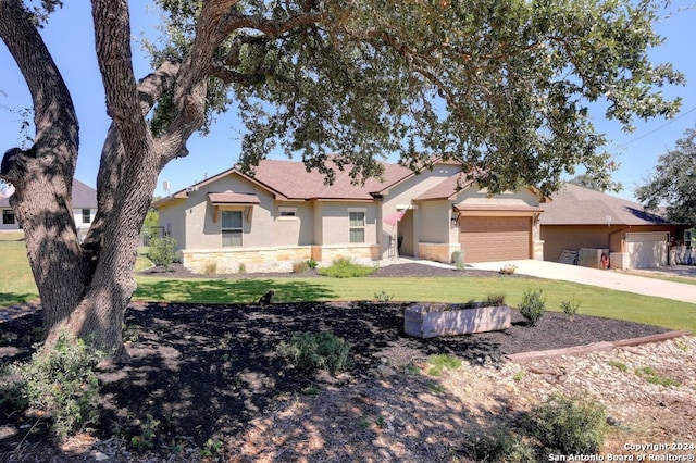 single story home with a garage and a front yard