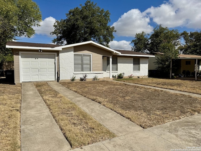 ranch-style home featuring a garage and a front yard