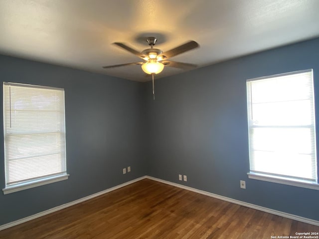 spare room featuring wood-type flooring and ceiling fan